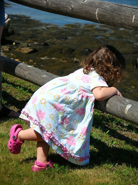 Little girl watching boats