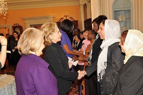 Secretary Clinton Shakes Hands With Honoree Colonel Shafiqa Quraishi of Afghanistan