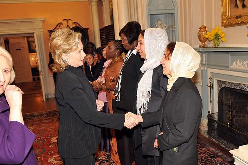 Secretary Clinton Shakes Hands With Honoree Shukria Asil