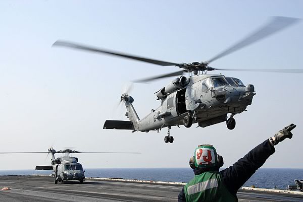 An HH-60H Sea Hawk helicopter assigned to the Black Knights of Helicopter Anti-Submarine Squadron (HS) 4 launches from the aircraft carrier USS Ronald Reagan (CVN 76).